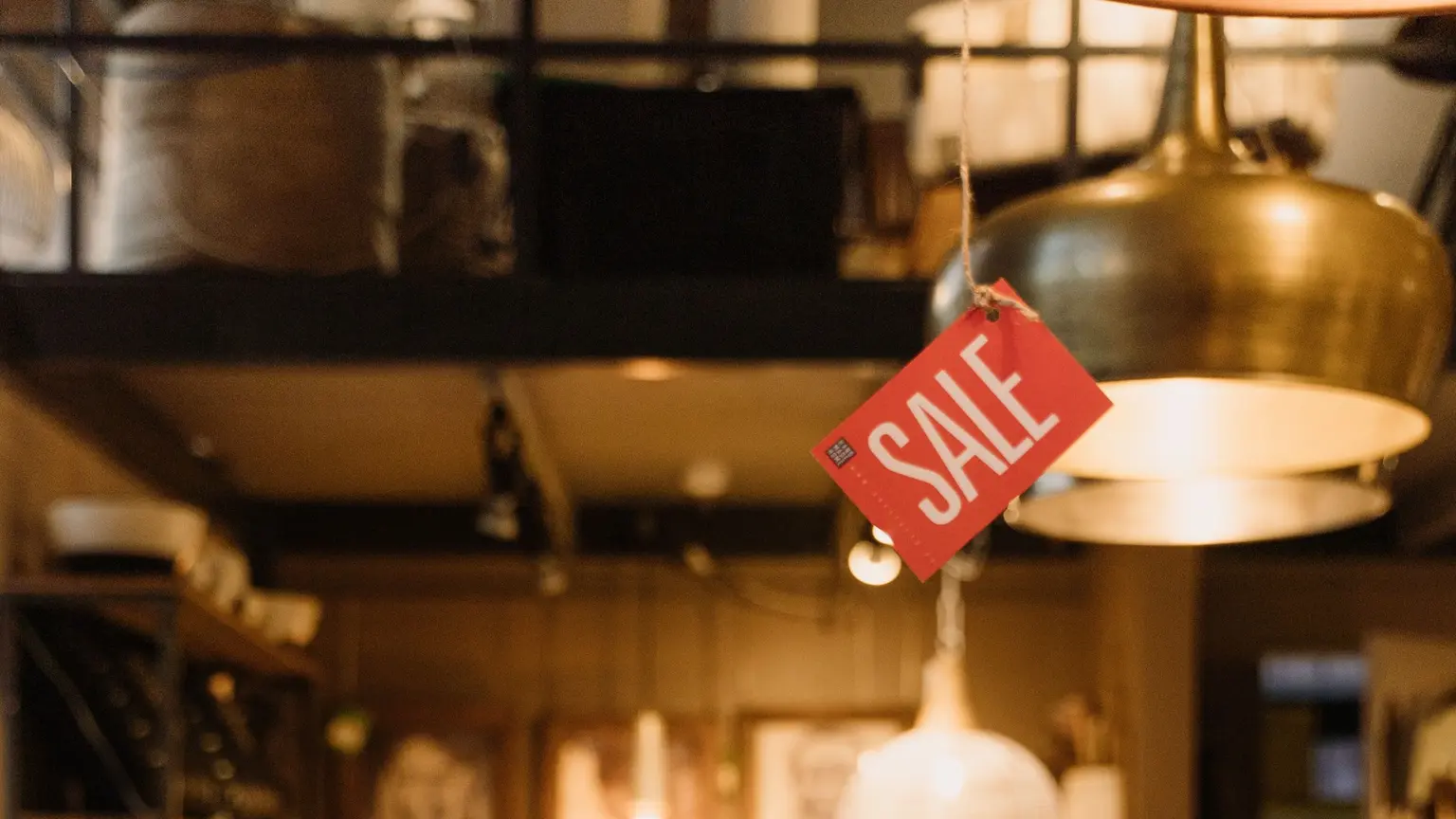 Warmly lit shop with a red SALE tag.